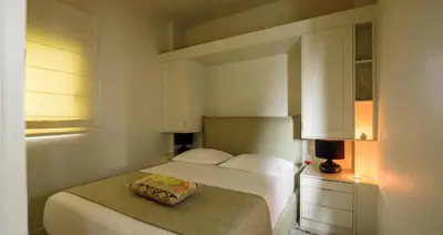 a bedroom with a bed with a pillow on it at THIRAMENOUS RESIDENCE in Athens