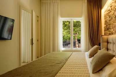 a bedroom with a large bed and a window at THIRAMENOUS RESIDENCE in Athens