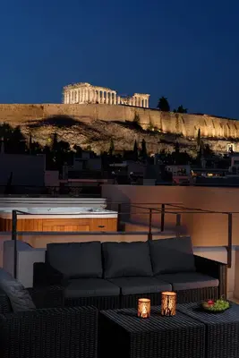 a couch sitting on top of a balcony with a building at THIRAMENOUS RESIDENCE in Athens