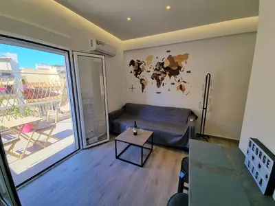 a living room with a couch and a table at WOW Penthouse Boutique in the heart of Historical Center in Athens