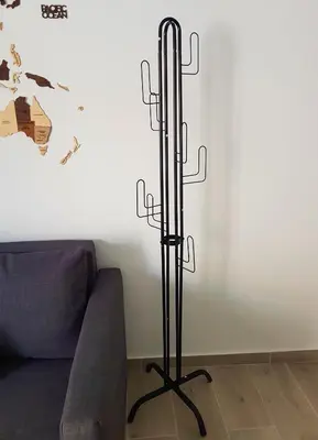 a black metal candle stand next to a couch at WOW Penthouse Boutique in the heart of Historical Center in Athens