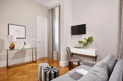 a living room with a couch and a desk at MiraMe Athens Boutique Hotel in Athens