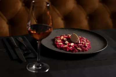a glass of wine next to a plate of food at MiraMe Athens Boutique Hotel in Athens