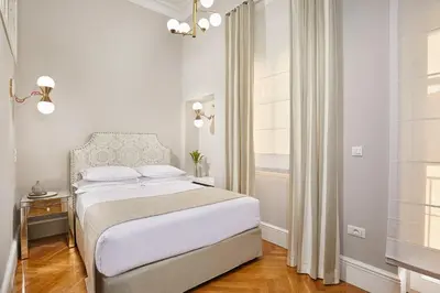 a white bedroom with a bed and a window at MiraMe Athens Boutique Hotel in Athens