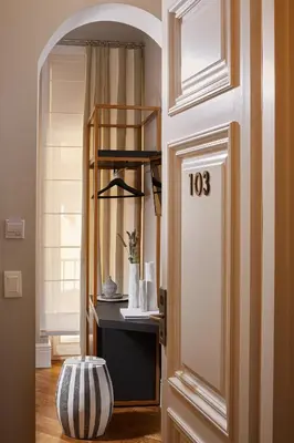 a hallway with a door with a vase on the floor at MiraMe Athens Boutique Hotel in Athens