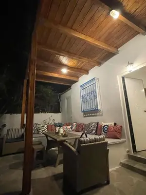 a living room with a couch and a table at Lagonisi MAGIC HOME RELAXATION in Kalívia Thorikoú