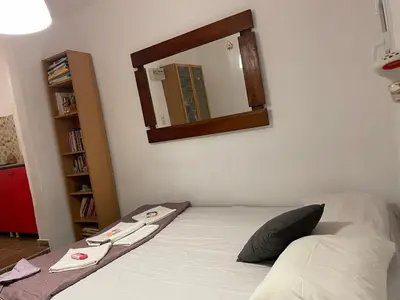 a bedroom with a bed with a mirror on the wall at Lagonisi MAGIC HOME RELAXATION in Kalívia Thorikoú
