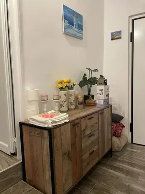 a room with a wooden cabinet with flowers on it at Lagonisi MAGIC HOME RELAXATION in Kalívia Thorikoú
