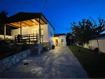 a house with a pavilion in the yard at night at Lagonisi MAGIC HOME RELAXATION in Kalívia Thorikoú