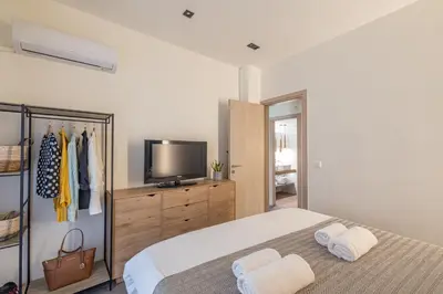a bedroom with a bed and a television on a dresser at Ports Crossroad E in Piraeus