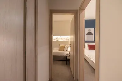 a hallway leading to a bedroom with a bed at Ports Crossroad E in Piraeus