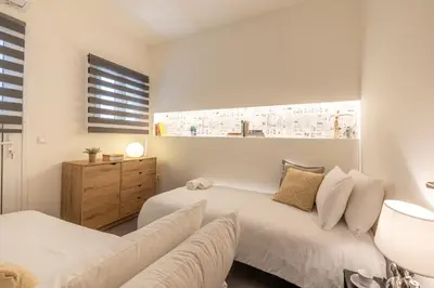a bedroom with two beds and a couch at Ports Crossroad E in Piraeus