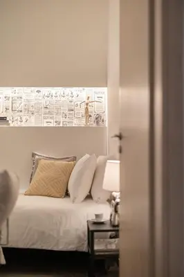 a bedroom with a bed and a table with a lamp at Ports Crossroad E in Piraeus
