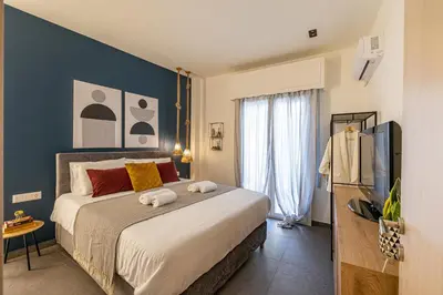 a bedroom with a large bed with a blue wall at Ports Crossroad E in Piraeus