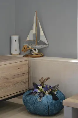 a blue pumpkin with a model ship on a counter at ''Stergiou Luxury Apartments'' με κοινη πισινα in Saronida