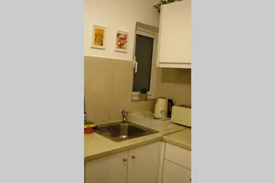 a small kitchen with a sink and a microwave at Kolonaki. Luxurious Studio in Athens