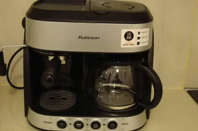 a black and white coffee maker sitting on a counter at Kolonaki. Luxurious Studio in Athens