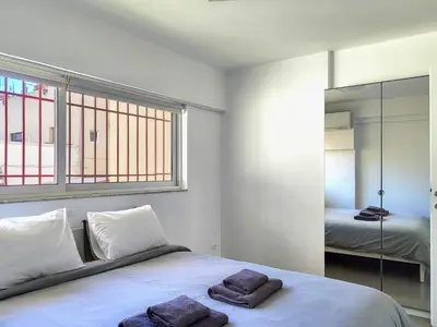 a bedroom with a bed with two towels on it at KYMA Apartments Athens 19 in Athens
