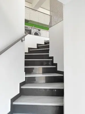 a staircase in a building with grey and white walls at KYMA Apartments Athens 19 in Athens