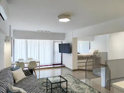 a living room with a couch and a table at KYMA Apartments Athens 19 in Athens