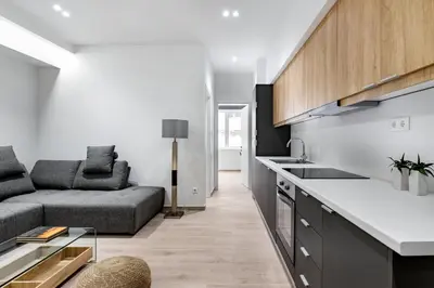 a kitchen and living room with a couch and a table at Central Boutique Apartment A1 in Athens