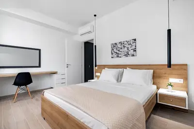 a bedroom with a large bed and a tv at Central Boutique Apartment A1 in Athens
