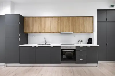 a kitchen with black appliances and wooden cabinets at Central Boutique Apartment A1 in Athens