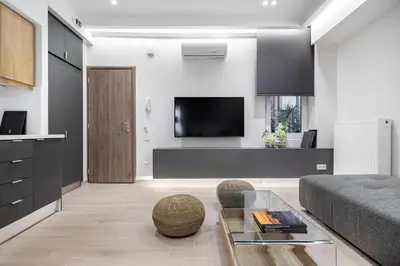 a living room with a couch and a tv at Central Boutique Apartment A1 in Athens