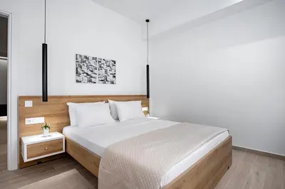 a bedroom with a large bed with a wooden headboard at Central Boutique Apartment A1 in Athens