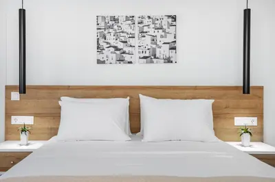 a bedroom with a white bed with two pillows at Central Boutique Apartment A1 in Athens