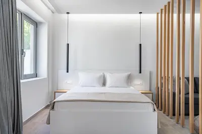 a bedroom with a large bed and a window at Central Boutique Apartment A2 in Athens