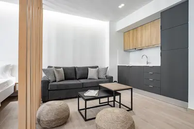 a living room with a couch and a table at Central Boutique Apartment A2 in Athens