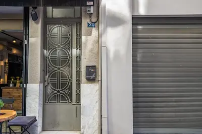 a pair of garage doors on the side of a building at Central Boutique Apartment A2 in Athens
