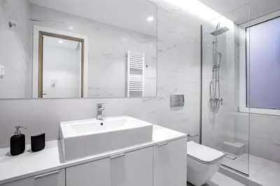 a white bathroom with a sink and a toilet at Central Boutique Apartment A2 in Athens