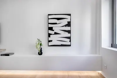 a white room with a black and white picture on the wall at Central Boutique Apartment A2 in Athens