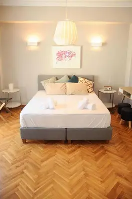 a bedroom with a bed with two towels on it at Lovely apartment in Plaka in Athens