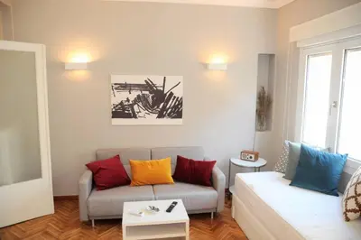 a living room with a couch with colorful pillows at Lovely apartment in Plaka in Athens