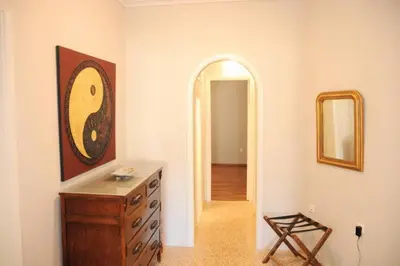 a room with a wooden dresser and a mirror at Lovely apartment in Plaka in Athens