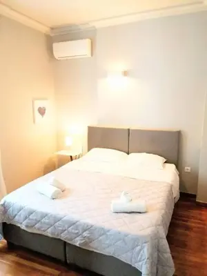 a bedroom with a bed with two towels on it at Lovely apartment in Plaka in Athens