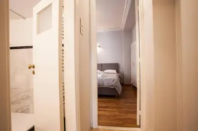a hallway with a bed in a small room at Lovely apartment in Plaka in Athens