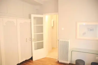 a room with a white door and a white cabinet at Lovely apartment in Plaka in Athens