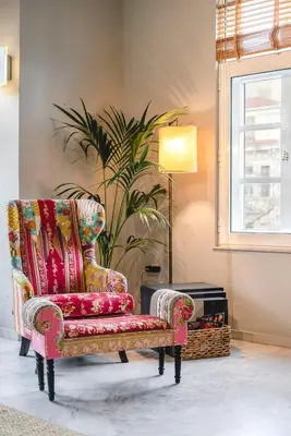 a living room with a chair and a plant at Athens Heart Superior Loft under Acropolis in Athens