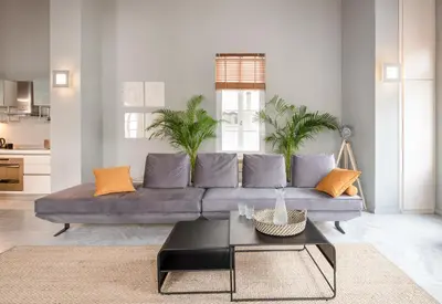 a living room with a gray couch with orange pillows at Athens Heart Superior Loft under Acropolis in Athens
