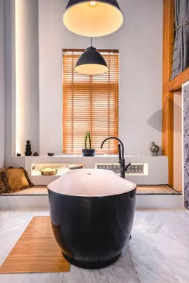 a bathroom with a large black tub and a sink at Athens Heart Superior Loft under Acropolis in Athens