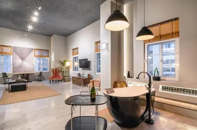 a living room with a table and a couch at Athens Heart Superior Loft under Acropolis in Athens