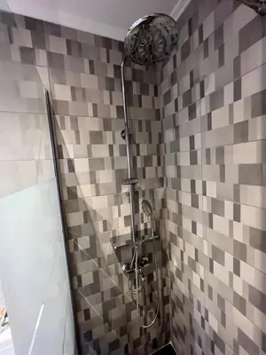 a shower in a bathroom with a tiled wall at Johns Cozy apartments -10 min from Athens Airport Self Check-In! in Spáta
