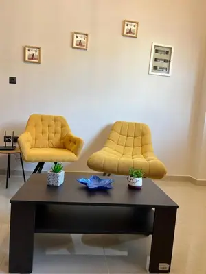 two yellow chairs sitting on top of a coffee table at Johns Cozy apartments -10 min from Athens Airport Self Check-In! in Spáta