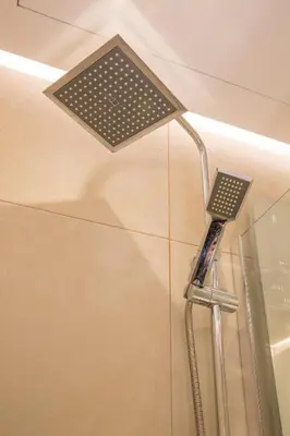 a shower with a shower head in a bathroom at Del Mar Luxury Apartment 30m From The Beach in Porto Rafti