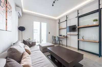 a living room with a couch and a table at Petraki Residence 1bdr Apt with balcony 1 min from Ermou str in Athens