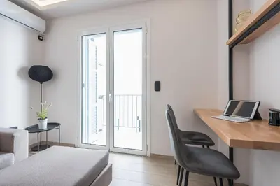 a living room with a desk with a laptop on it at Petraki Residence 1bdr Apt with balcony 1 min from Ermou str in Athens